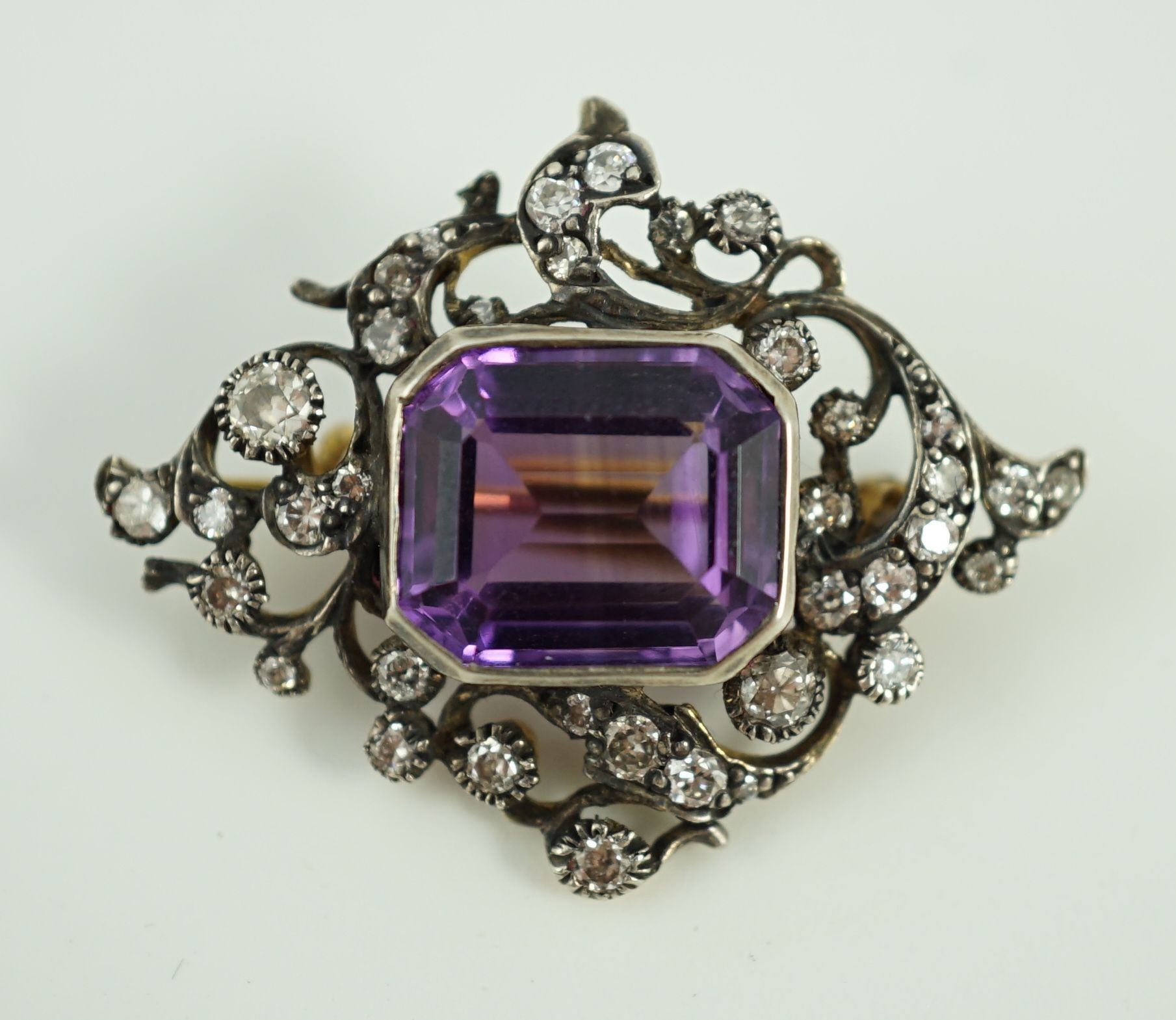 A Victorian gold and silver, emerald cut amethyst and diamond cluster set brooch
